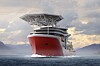 Stort rødt offshore støtteskip med overbygg og kraner til havs.